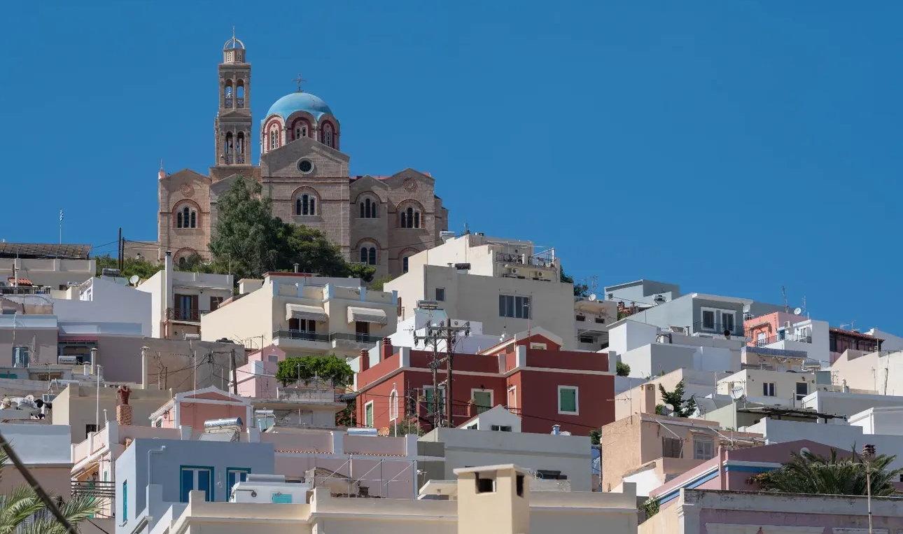 Ermoupoli and the Anastasi church rising above the Cycladic rooftops