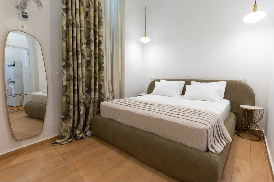 Amorosa bedroom — double bed dressed in hand-loomed linen in morning light